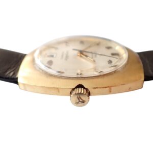 Vintage gold men's wristwatch with black leather strap and analog dial.