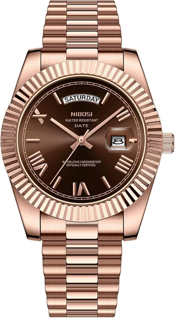 The Nibosi Classic Day Date Watch 2628 features a rose gold case, brown dial with Roman numerals and three hands. It displays the day at the top, date at 3 o’clock, and “NIBOSI” beneath the day display.