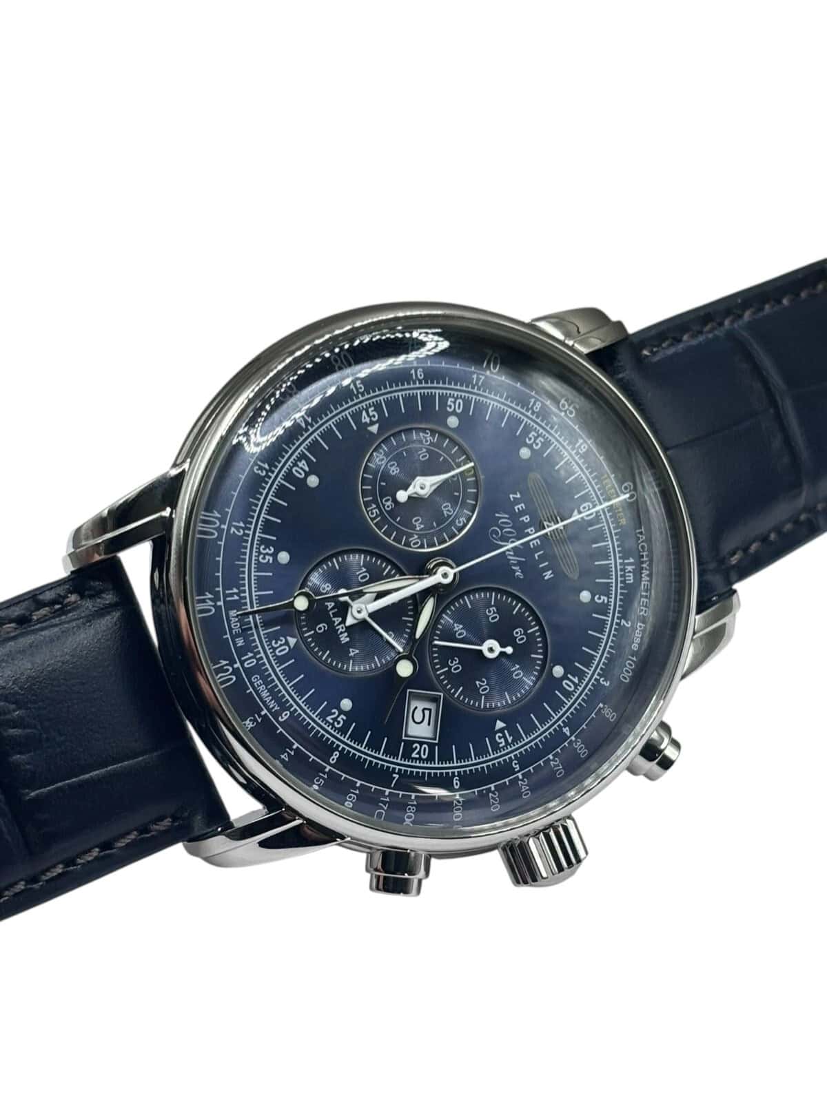 A close-up of the Zeppelin Airship Commemorative Version Men's Watch 2025 featuring a dark blue dial, silver casing, blue leather strap, three chronograph sub-dials, and a date window.