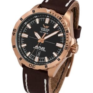 The Vostok Europe Almaz Automatic Line NH35A/320B259 features a rose gold case, black dial with white hour markers, a date display at 6 o’clock, and a brown leather strap accented with white stitching.