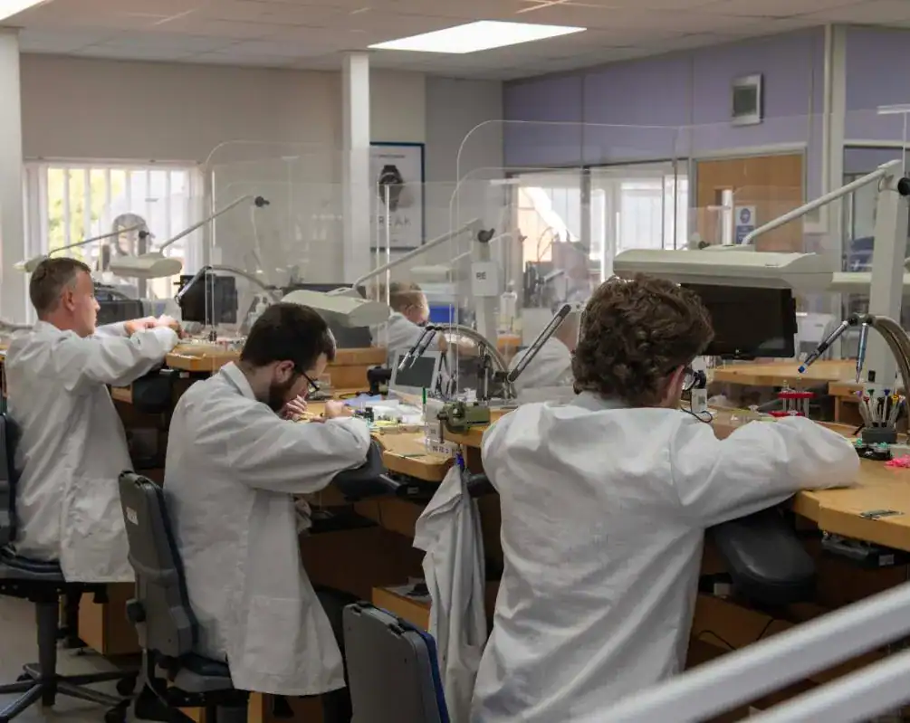 Watchmakers at work in the Swiss Time Services workshop